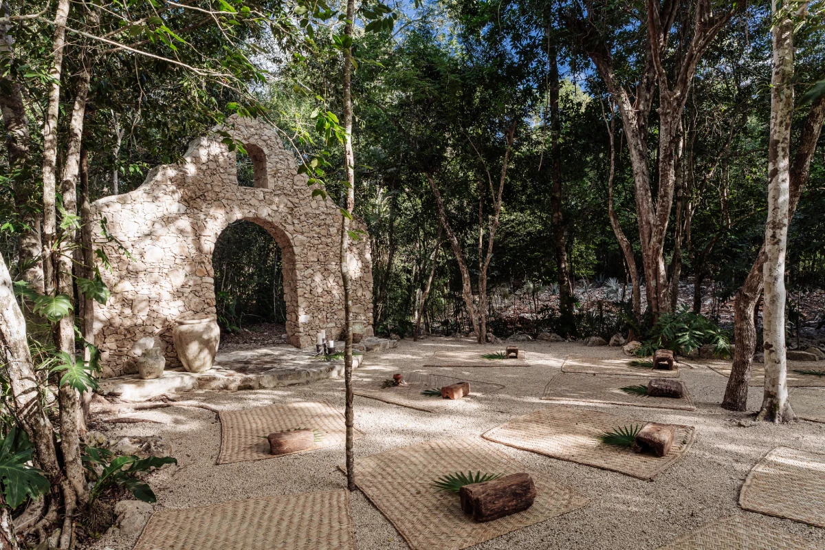 Stone arch and shaded jungle clearing at the estate